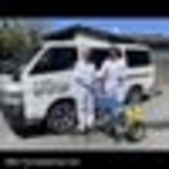 Mike The Spiderman team in white overalls beside the white work van